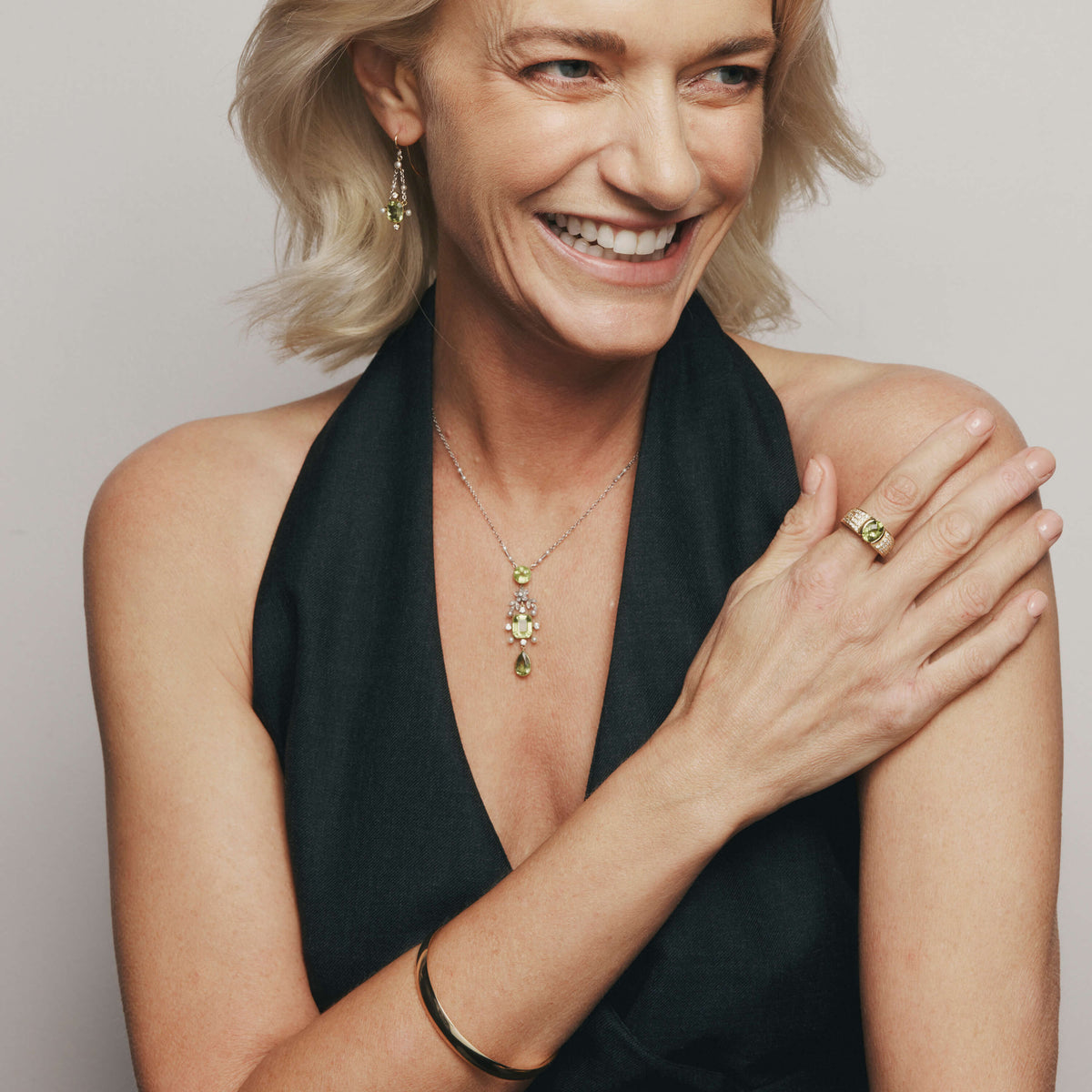 Model wearing Vintage peridot, pearl and diamond earrings, necklace and ring
