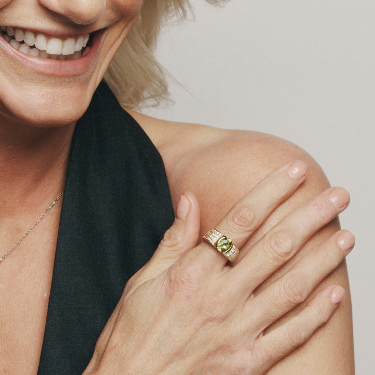 Model wearing natural diamond and peridot Deja Vu ring