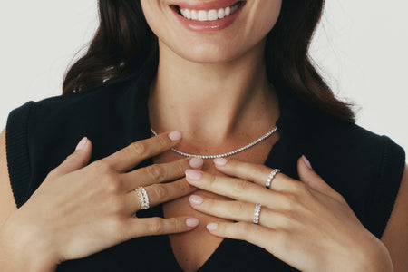 Model wearing diamond Panorama Rings and diamond Panorama Necklace with a neutral background